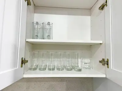 a row of glasses sitting on a shelf at SUPER CLOSE Beach, Airport, port, Downtown, Wynwood in Miami