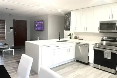 a kitchen with white cabinets and a stove top oven at SUPER CLOSE Beach, Airport, port, Downtown, Wynwood in Miami
