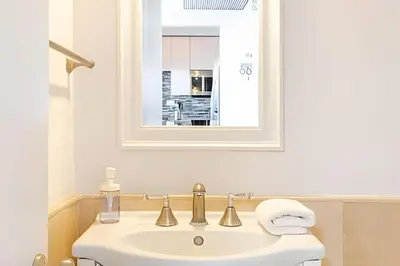a bathroom with a white sink and a mirror at Pavilion -Amazing bay sunset-Miami Beach in Miami Beach