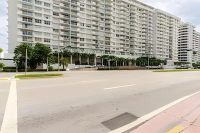 an empty parking lot in front of a large apartment building at Pavilion -Amazing bay sunset-Miami Beach in Miami Beach
