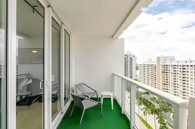 a balcony with chairs and a view of a city at Pavilion -Amazing bay sunset-Miami Beach in Miami Beach