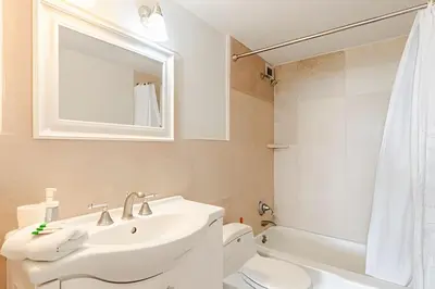 a bathroom with a sink and a toilet and a mirror at Pavilion -Amazing bay sunset-Miami Beach in Miami Beach