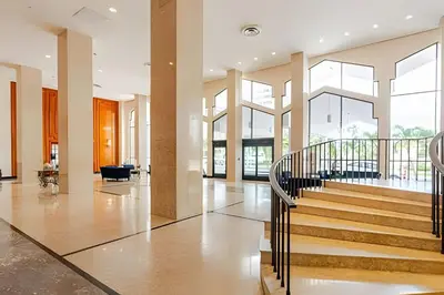 a lobby with a staircase in a building at Pavilion -Amazing bay sunset-Miami Beach in Miami Beach