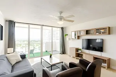 a living room with a couch and a tv at Pavilion -Amazing bay sunset-Miami Beach in Miami Beach