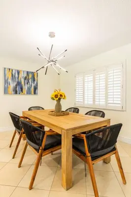 a dining room with a wooden table and chairs at Spacious 4 Bedroom 3 Bathroom House with Heated Pool and Outdoor Shower close to FFL Airport and Cruise Port in Plantation