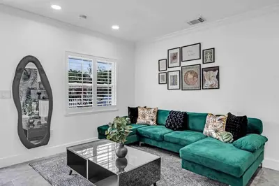a living room with a green couch and a mirror at Miami Luxury Home! Next to Miami airport and beach in Miami