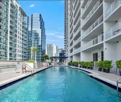 a swimming pool in a building with tall buildings at Brickell Center w/City & Bay View + FREE Parking! in Miami