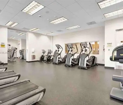 a gym with a row of treadmills at Brickell Center w/City & Bay View + FREE Parking! in Miami