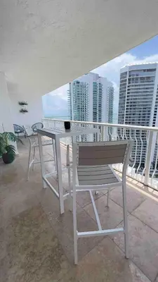 a table and chairs on a balcony with buildings at Brickell Center w/City & Bay View + FREE Parking! in Miami