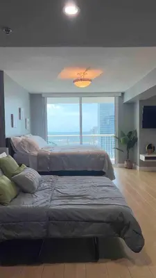 a large bedroom with two beds and a large window at Brickell Center w/City & Bay View + FREE Parking! in Miami