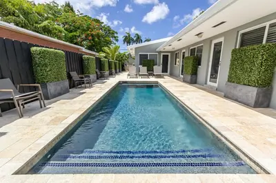 a swimming pool in front of a house at Wiltonplex B in Fort Lauderdale