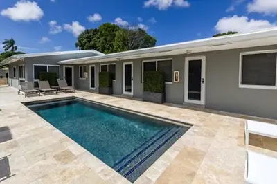 a swimming pool in front of a house at Wiltonplex B in Fort Lauderdale