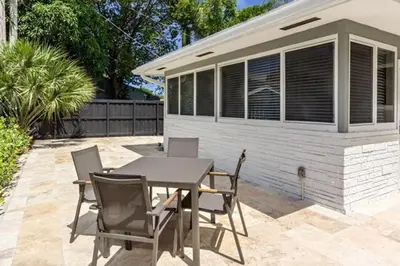 a patio with a table and chairs and a building at Wiltonplex D in Fort Lauderdale