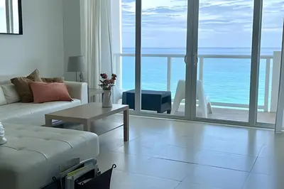 a living room with a white couch and a view of the ocean at Pavilion - Great ocean view -Miami Beach in Miami Beach