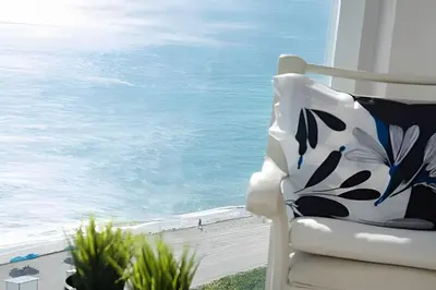 a white chair sitting on a balcony looking out at the ocean at Pavilion - Great ocean view -Miami Beach in Miami Beach