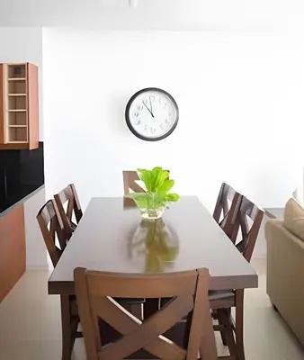 a dining room table with a clock on the wall at Pavilion - Great ocean view -Miami Beach in Miami Beach