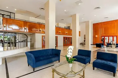 a living room with blue couches and a glass table at Pavilion - Great ocean view -Miami Beach in Miami Beach
