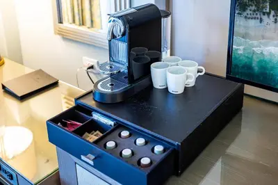 a table with a coffee maker and cups on it at Gorgeous Partial Ocean View I The Ritz Carlton in Miami