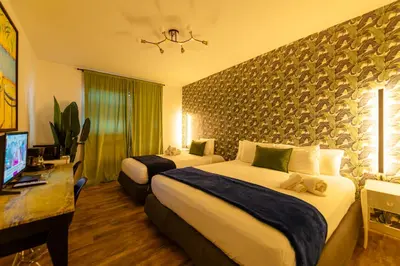 a hotel room with two beds and a television at 6768 Collins Miami Stays in Miami Beach