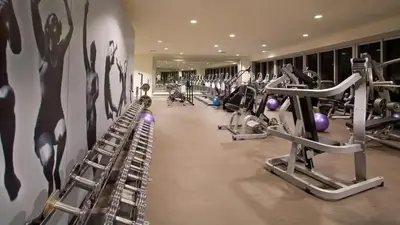 a gym with several tread machines in a room at Gorgeous Bay & City view condo in Brickell with Free SPA in Miami