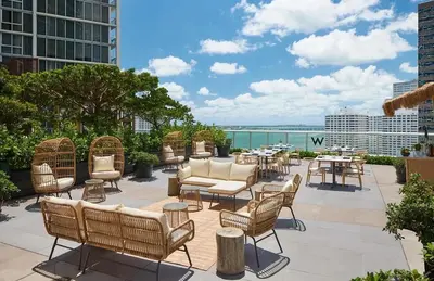 a patio with chairs and tables on a building at Gorgeous Bay & City view condo in Brickell with Free SPA in Miami