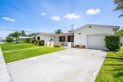 a house with a driveway and a garage at Centrally Located 4BDR Pool Home in Miami in Miami Gardens