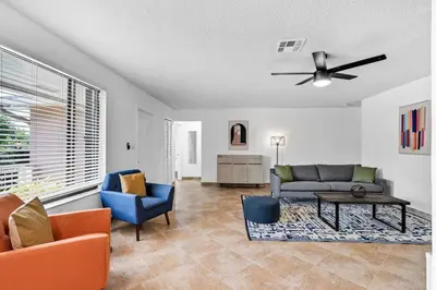 a living room with a couch and chairs and a ceiling fan at Centrally Located 4BDR Pool Home in Miami in Miami Gardens