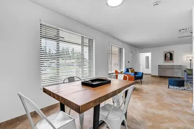 a living room with a wooden table and chairs at Centrally Located 4BDR Pool Home in Miami in Miami Gardens