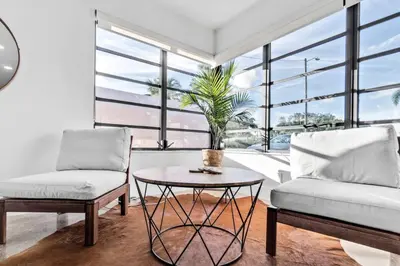 a living room with a couch and a table at Modern Pool Home Great for Families in Hollywood