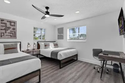a bedroom with two beds and a ceiling fan at Modern Home 3 Bedrooms with Pool, 18 minutes to Ocean in Hollywood