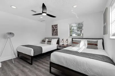 a bedroom with two beds and a ceiling fan at Modern Home 3 Bedrooms with Pool, 18 minutes to Ocean in Hollywood