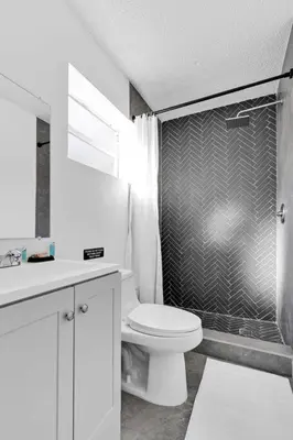a white bathroom with a toilet and a shower at Modern Home 3 Bedrooms with Pool, 18 minutes to Ocean in Hollywood