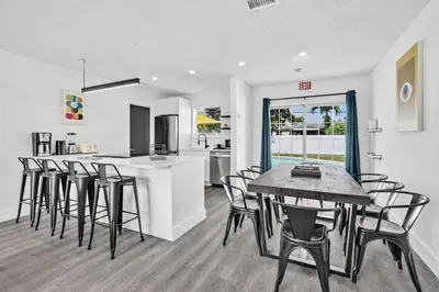 a kitchen and dining room with a table and chairs at Modern Home 3 Bedrooms with Pool, 18 minutes to Ocean in Hollywood