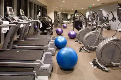 a gym with several treadmills and exercise machines at Waterfront Luxury Apartment 2 Bedrooms IconBrickell in Miami