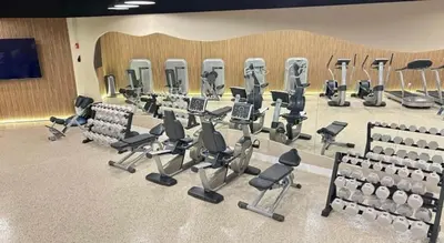 a gym with a bunch of chairs and machines at Beachfront Property Pool Gym Tennis Miami Beach! in Miami Beach