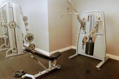 a room with a gym with a treadmill and a mirror at Tides Ocean Retreat by Cielo Stays in Hollywood