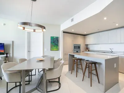 a kitchen with a table and chairs and a counter at Luxury Ocean Escape by Cielo Stays in Hollywood