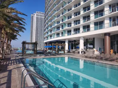 a swimming pool in front of a building at Luxury Ocean Escape by Cielo Stays in Hollywood
