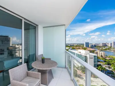 a balcony with a table and chairs and a view of the city at Luxury Ocean Escape by Cielo Stays in Hollywood