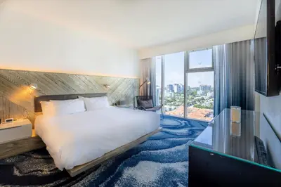 a hotel room with a bed and a large window at Beachfront-Spacious W Residence in Fort Lauderdale