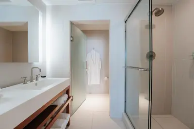 a white bathroom with a sink and a shower at Beachfront-Spacious W Residence in Fort Lauderdale