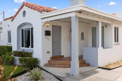 a white house with a porch and a door at Lovely 2 bedroom Studios-Suite Walking Distance To Ocean in Hollywood