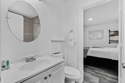 a white bathroom with a sink and a mirror at Lovely 2 bedroom Studios-Suite Walking Distance To Ocean in Hollywood