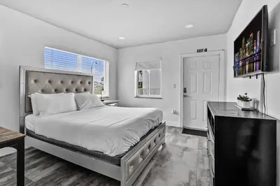 a bedroom with a bed and a desk and a television at Lovely Studio Walking Distance To Ocean - Suite 5 in Hollywood