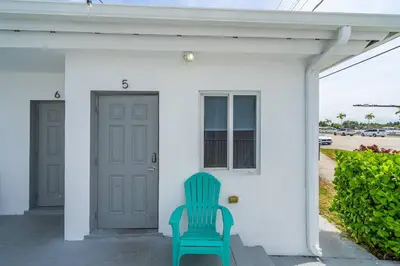a green chair sitting on the porch of a house at Lovely Studio Walking Distance To Ocean - Suite 5 in Hollywood