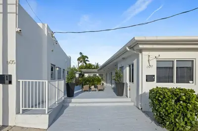 a walkway between two white buildings with plants at Lovely Studio Walking Distance To Ocean - Suite 5 in Hollywood