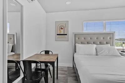 a bedroom with a bed and a table and chairs at Lovely Studio Walking Distance To Ocean - Suite 5 in Hollywood