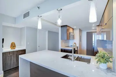 a kitchen with a white counter top and a sink at Miami Vibes! Biscayne Bay Water and Park Views! in Miami