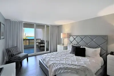 a bedroom with a large bed and a balcony at Miami Vibes! Biscayne Bay Water and Park Views! in Miami