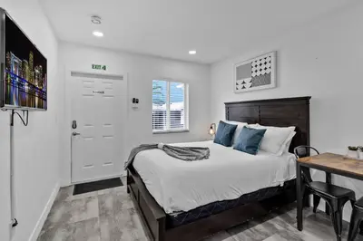 a bedroom with a bed and a desk in it at Lovely Studio Walking Distance To Ocean - Suite 7 in Hollywood